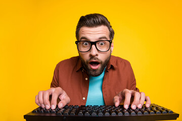Photo portrait of bearded man staring playing video game crazy nerd pressing keyboard spectacles...