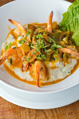 Shrimp and Grits. Grits and old bay seasoned jumbo shrimp topped with spices and micro greens. Classic American Diner Style Breakfast or Brunch menu item. Traditional low country southern staple. 