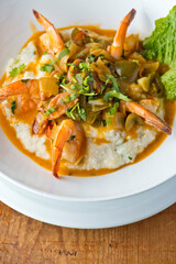 Shrimp and Grits. Grits and old bay seasoned jumbo shrimp topped with spices and micro greens. Classic American Diner Style Breakfast or Brunch menu item. Traditional low country southern staple. 