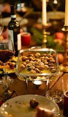 baked stuffed snails for a candlelit dinner party. Delicacy. romantic date. Original dishes. Low light. Selective focus. christmas and new year