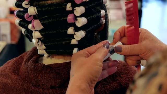 People having a perm in a hairdressing salon with 4k resolution.
