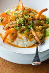 Shrimp and Grits. Grits and old bay seasoned jumbo shrimp topped with spices and micro greens. Classic American Diner Style Breakfast or Brunch menu item. Traditional low country southern staple. 