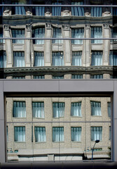 Reflections of architecture on the mirrored glass windows of a building in an American metropolis