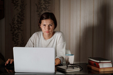 female student freelancer working at home on a task