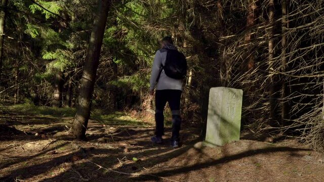 Thurst in the woods near the old border pillar of the Czech-Polish border. Travel concept. Carpathian mountain range. Ukraine. 4K