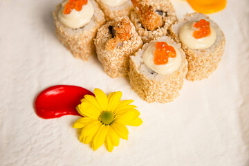 Top view of Japanese sushi roll Ebi Tempura with black tiger shrimp (prawn) served with sauce and...
