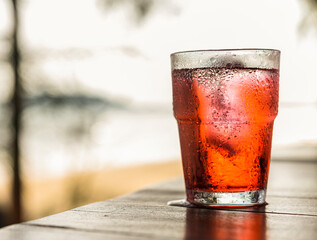 glass of red soda with ice