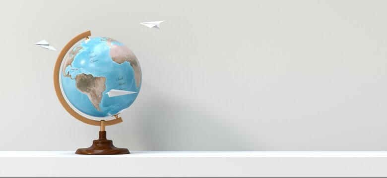 terrestrial globe on a shelf with paper planes