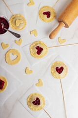 The process of making small cherry pies on sticks on Valentine's Day. Raw cherry pie pops.