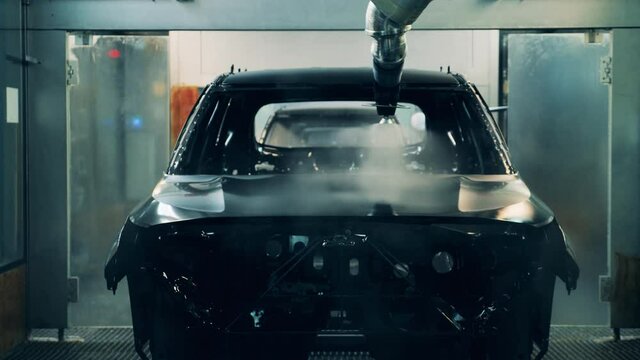 Spraying machine is galvanizing a car in the plant unit
