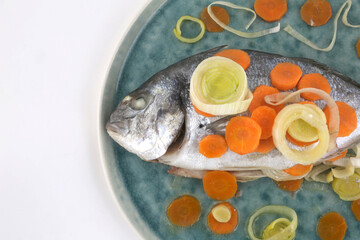 dorada fish with carrots and leeks as sea food