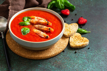 Traditional homemade gazpacho cold soup. Tomato soup puree gazpacho with tomatoes served seafood on a stone background. Copy space.