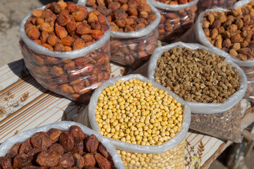 Sacks of chickpea and dried apricots at the market. Uzbekistan