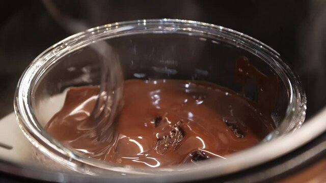 Close-up process of melting chocolate in a water bath