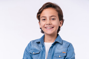 Cropped portrait of a handsome young boy smiling in casual clothes isolated over white background © InsideCreativeHouse