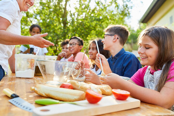 Group of kids has fun learning to cook