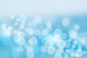 Abstract blurred festive delicate winter christmas or Happy New Year background with shiny blue and white bokeh lighted circles and bubbles. Space for your design. Card concept.