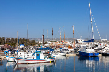 Fototapeta na wymiar Fishing boats in Paphos Harbour Cyprus which is a popular travel destination attraction landmark of the Mediterranean island tourist resort, stock photo image