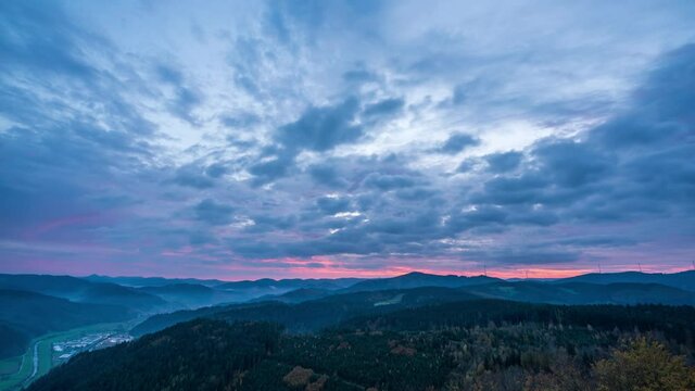 At dusk, time lapse of dark clouds and red burning clouds over Black Forest, shot on Urenkopfturm
