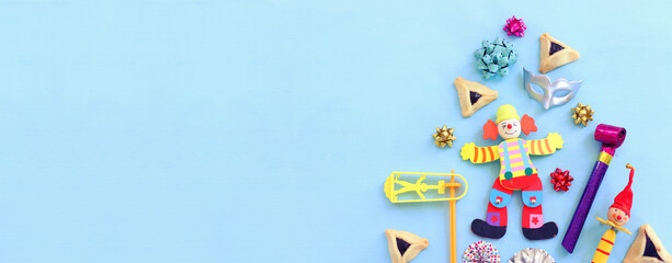 Purim celebration concept (jewish carnival holiday) over wooden blue background. Top view, flat lay