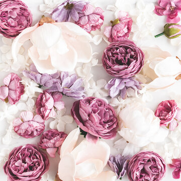 Flowers composition. White and purple flowers on marble background. Flat lay, top view
