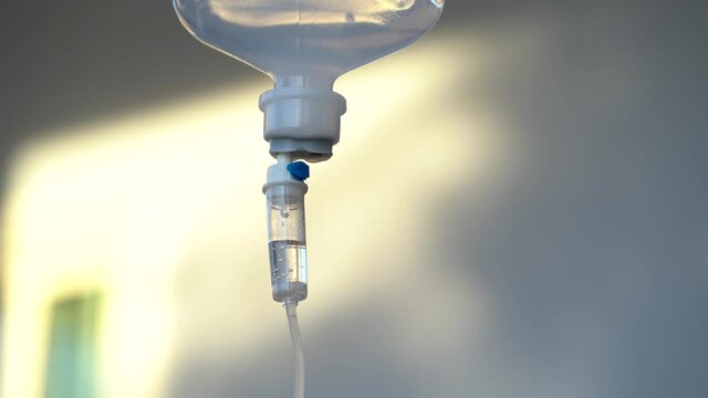 Closeup of IV drip 80 cc per hr. in hospital. Intravenous saline solution. IV loading. 
