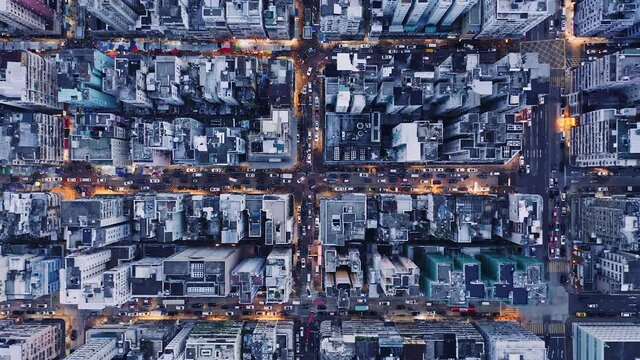 Aerial overhead view of city at night with buildings and streets in Kowloon, Hong Kong