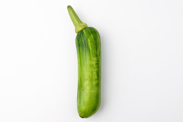 Elongated zucchini on white background