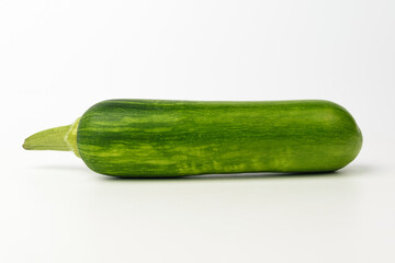 Elongated zucchini on white background