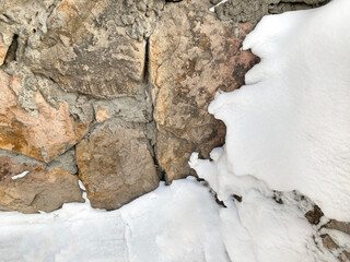 Old brown stone and snow background, grunge winter texture