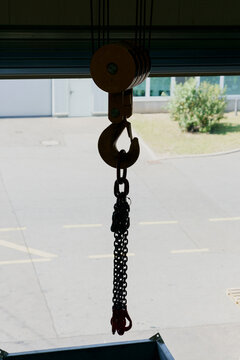 Cable winch hook with chains at loading dock doorway
