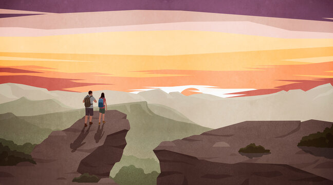 Couple hiking and enjoying scenic majestic mountain view at sunset

