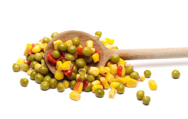 Mexican salad and wooden spoon, vegetables mix with corn, peas and paprika isolated on white background