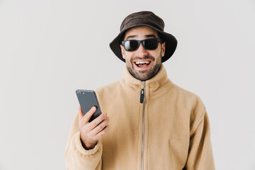 Portrait of a happy young man wearing beige jacket