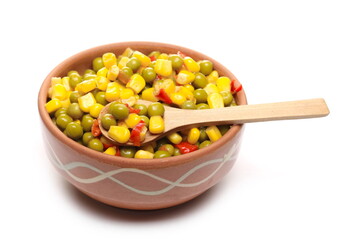Mexican salad and wooden spoon in clay bowl, vegetables mix with corn, peas and paprika isolated on white background