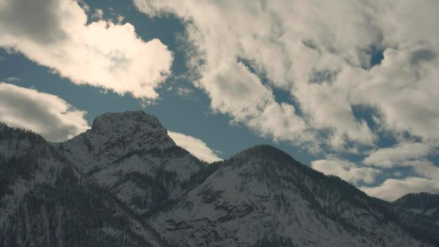 Beautiful view of the mountain in the Lienz Dolomites in winter. The mountain landscape is full of snow. The clouds are moving. Time-lapse.