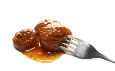 Fruit preserves made from figs, jam with metal kitchen fork isolated on white background