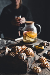 Woman is sitting with Hot tea with fresh grapefruit on wooden tablet. Healthy drink, Eco, vegan.