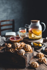 Tasty cakes with Hot tea with slices of fresh grapefruit on wooden tablet. Healthy drink, Eco, vegan