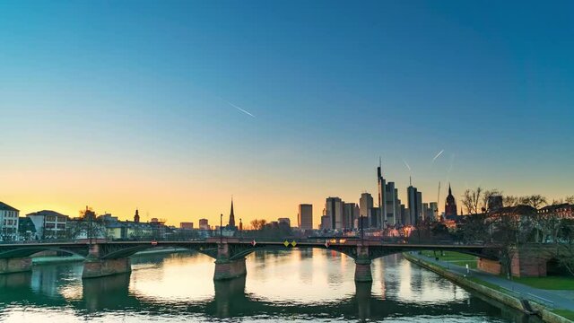 Time lapse of Frankfurt skyline at sunset. The Main river in Germany on evening