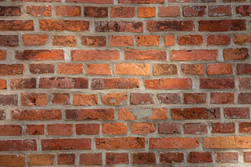 Hintergrund - Textur einer orange-roten Backsteinwand