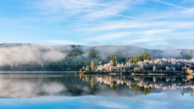 time lapse, fog on the lake near the Black Forest lifting in the early morning. Landscape of Freiburg, Germany