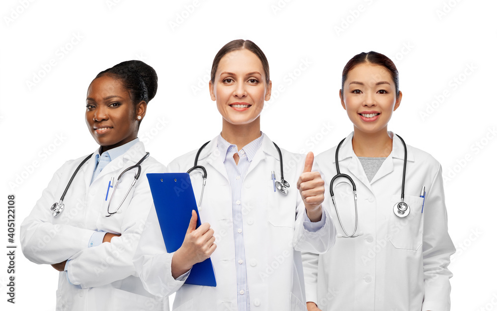 Wall mural medicine, profession and healthcare concept - international group of happy smiling female doctors in white coat showing clipboard and thumbs up gesture