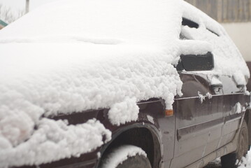 the car is covered with snow in winter