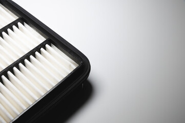 Automotive internal combustion engine filter close-up. Detail of a new car part on gray gradient background