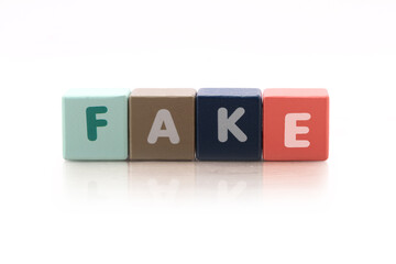 Cubes each with a letter on it written the word fake
