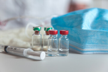 vaccine bottles and syringe for injection