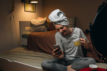 teenage girl applying face mask in her room at home