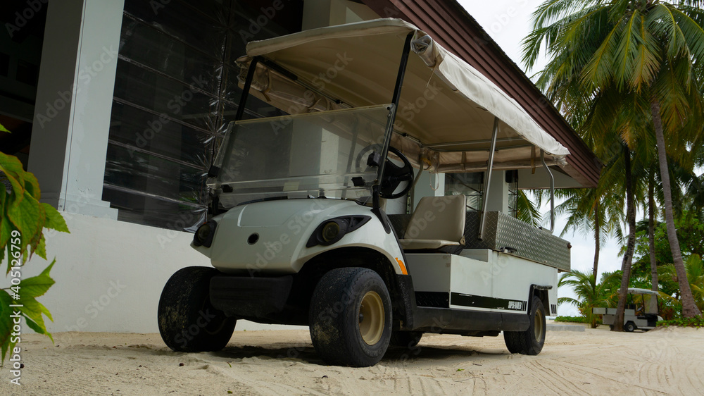 Wall mural a small golf car. transport for the transportation of guests.