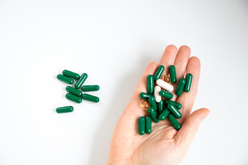 hand holding piils, capsules